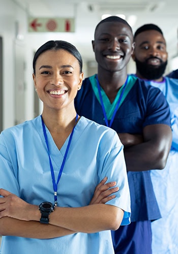 Smiling CritiCare nurses in scrubs ready to work